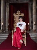Woman in red satin on a throne, wearing Plate XXII